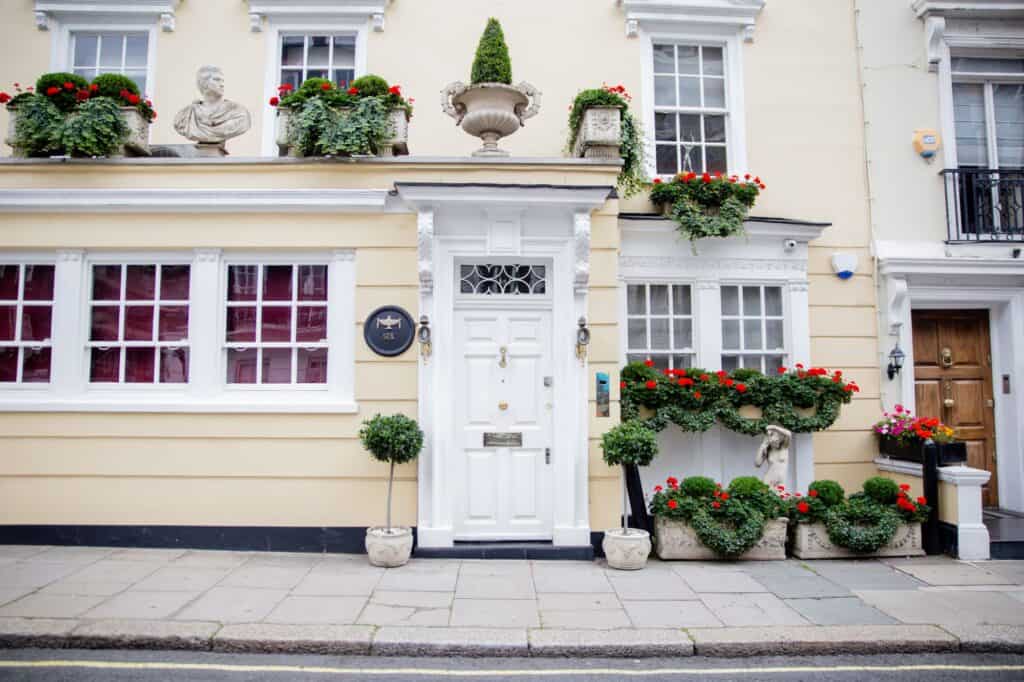 Front of a yellow house with flowers