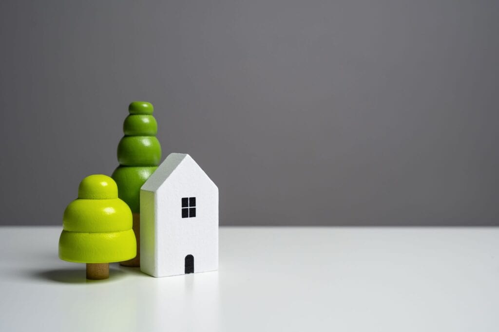 A house and trees figurine in the concept of moving houses