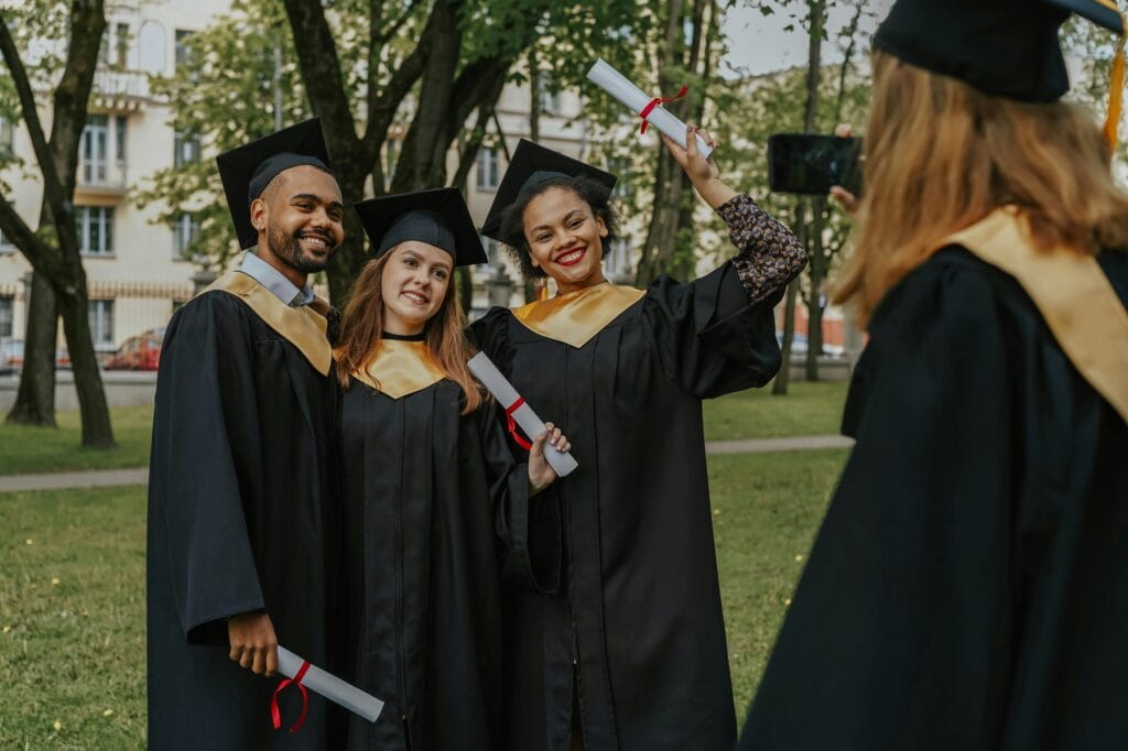 Graduating students taking group photos after the ceremony