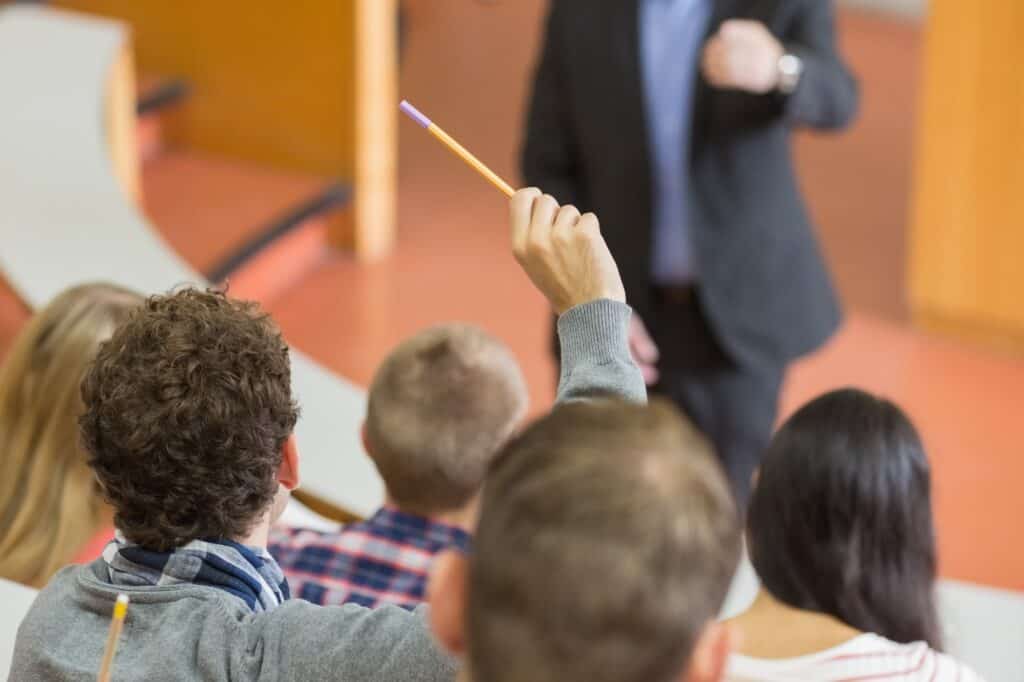 Cropped image of a teacher and his students in a lecture hall